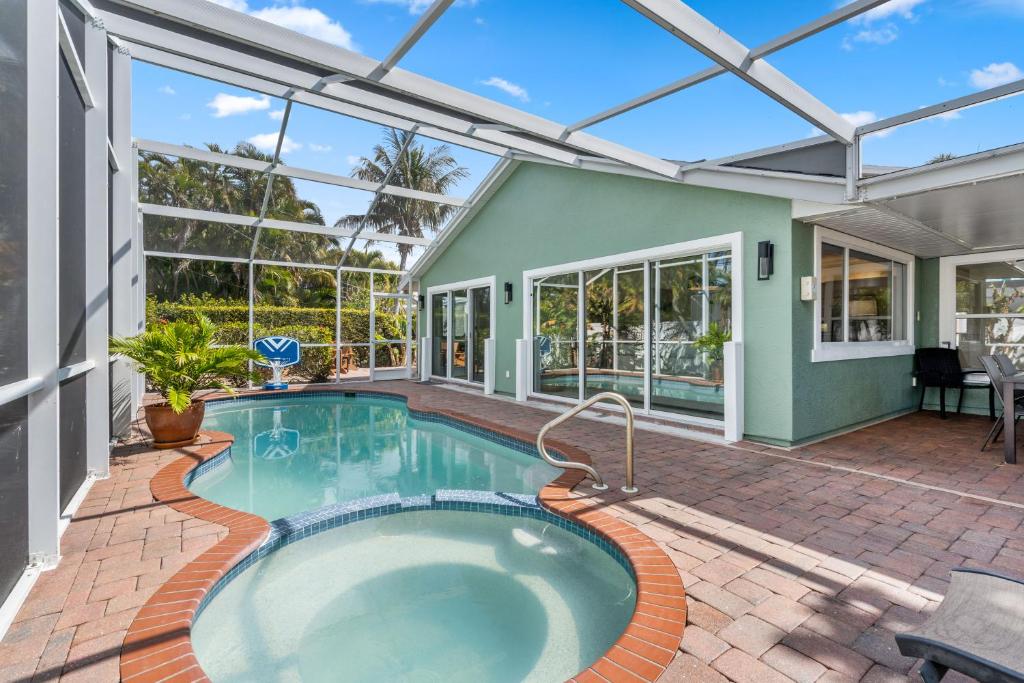 an indoor swimming pool in a house with a patio at Enclosed pool spa - Stillpoint by SeaBreeze Vacation in Holmes Beach