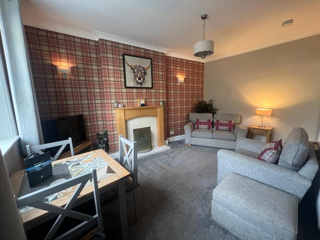 a living room with a couch and a fireplace at PERGOLA Cottage in Melrose