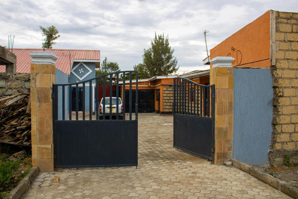 an entrance to a house with a black gate at Ziwa View Apartments in Goat Island