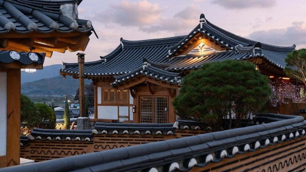 an asian style building with a black roof at Gyeongju Oru Hanok Stay in Gyeongju