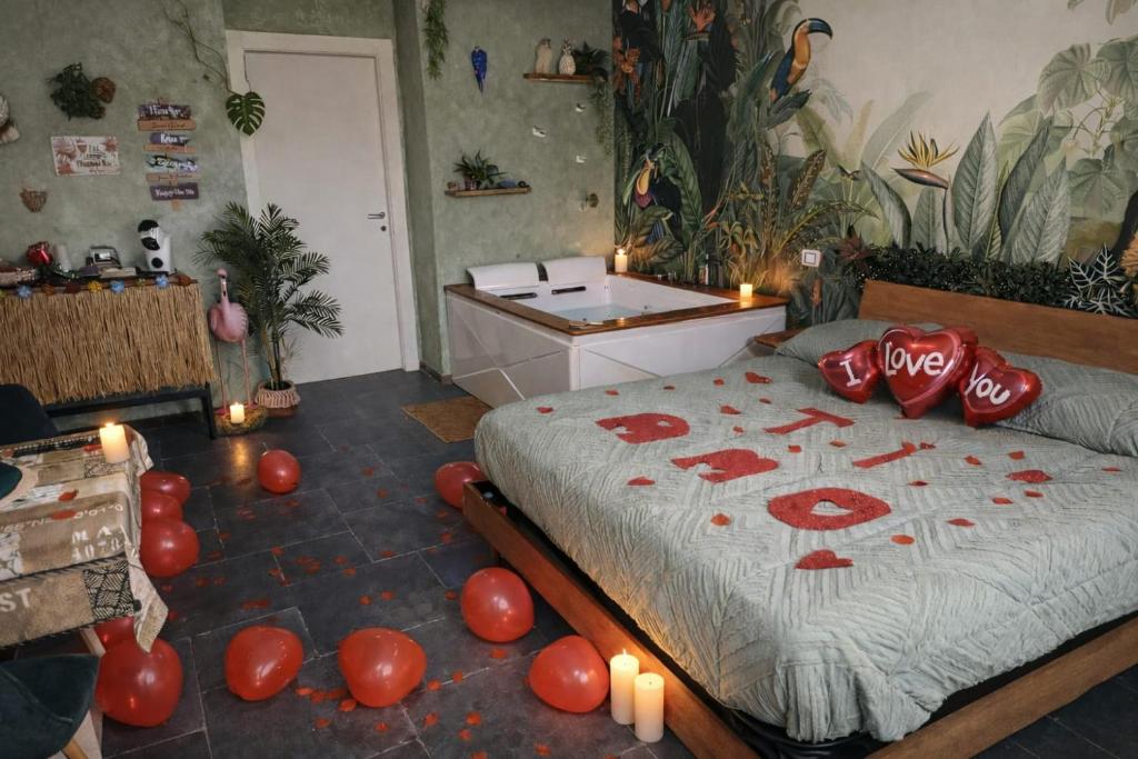 a bedroom with a bed with candles and a desk at Suite Amazzonia in Taranto