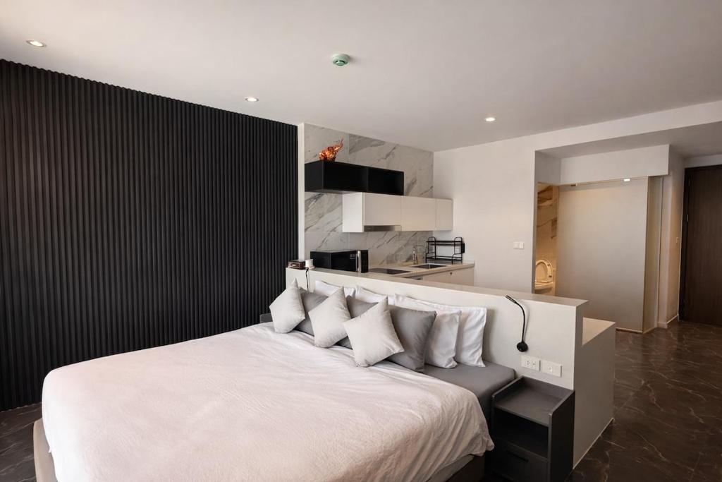 a bedroom with a large white bed with white pillows at Utopia Dream in Rawai Beach