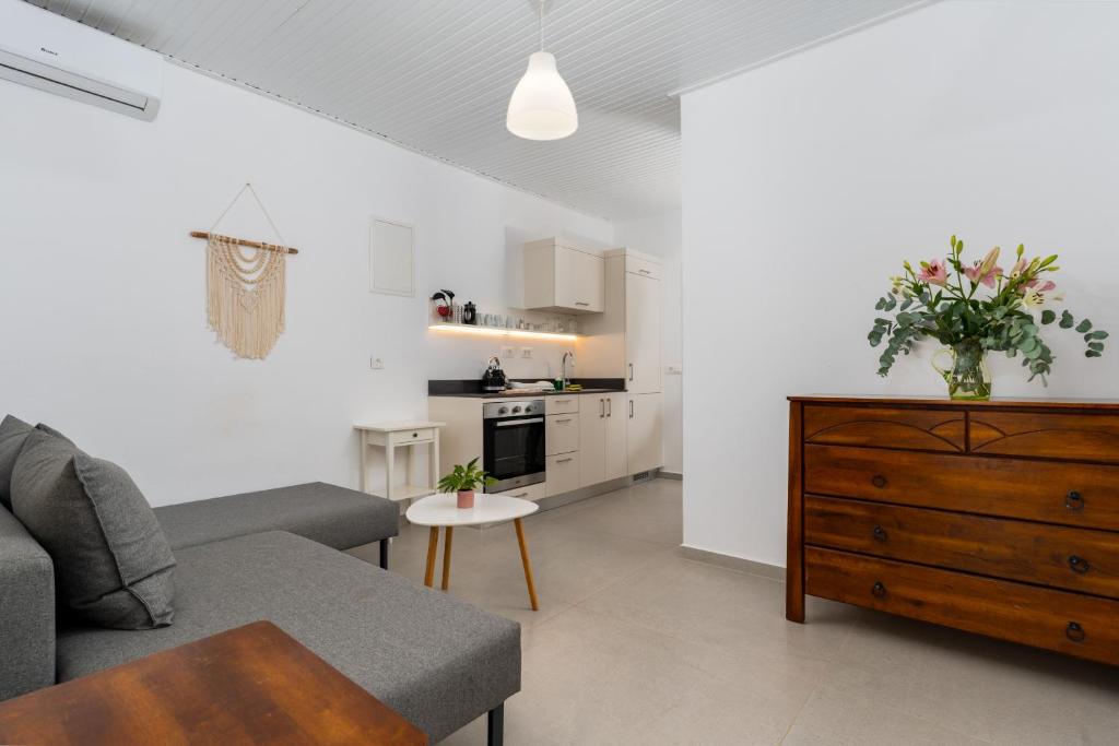 a living room with a couch and a table at Stay in Falassarna Rooms & Apartments in Falasarna