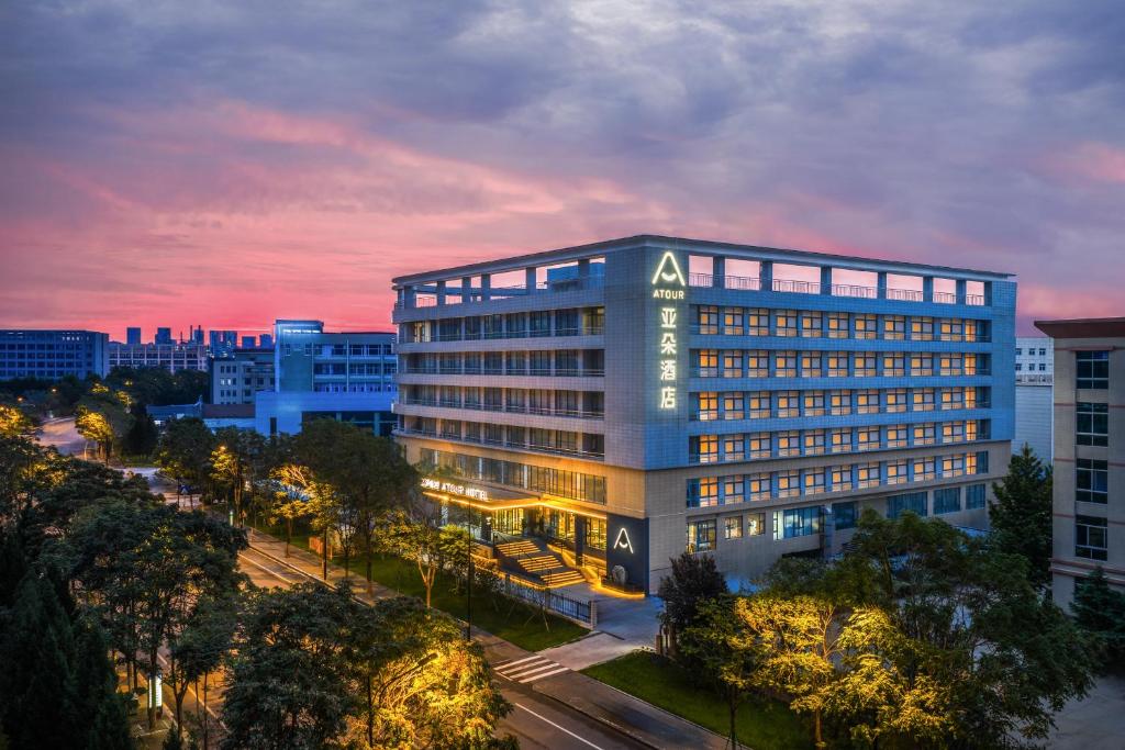 a large building with lights on in a city at Atour Hotel Jinan High-tech Wanda Plaza Tiancheng Road in Jinan