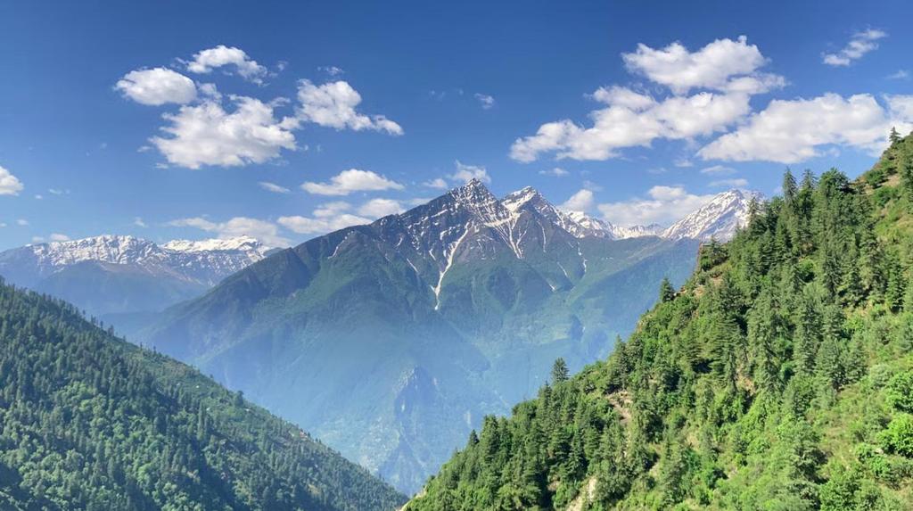 a view of a mountain range with snow capped mountains at Alavyahomestay in Kilba