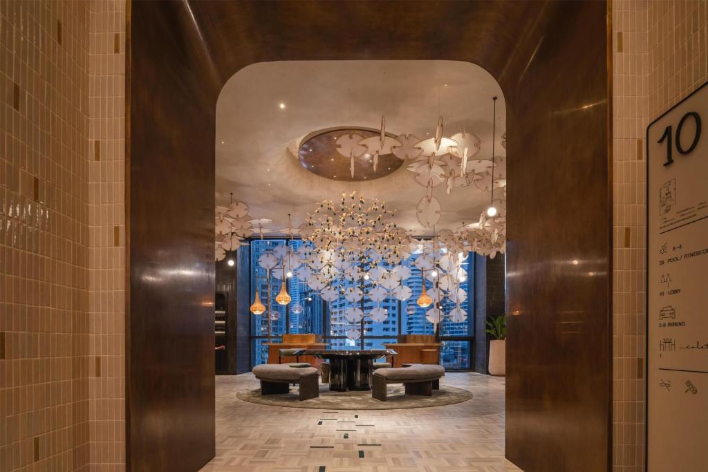 A lobby entrance opens onto a bright lounge with city-facing windows.