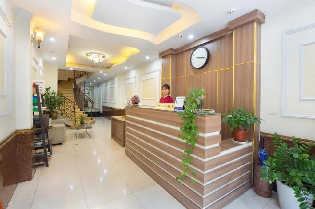 a woman sitting at a counter in a restaurant at Hanoi Spoon Boutique Hotel in Hanoi