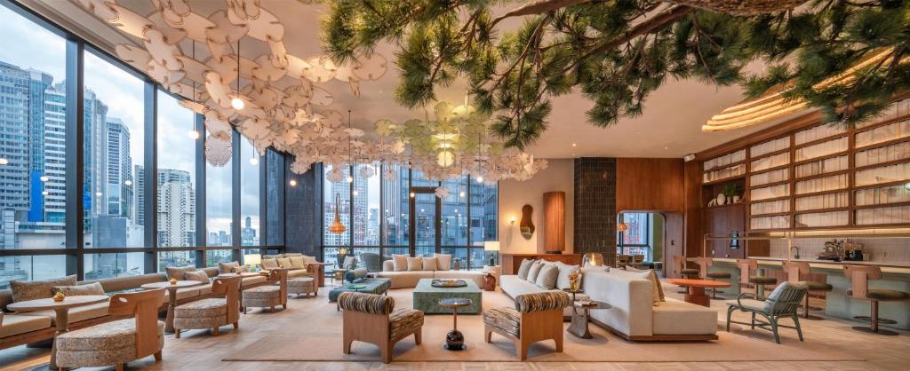 A spacious lounge lobby with skyline-facing windows and varied seating.