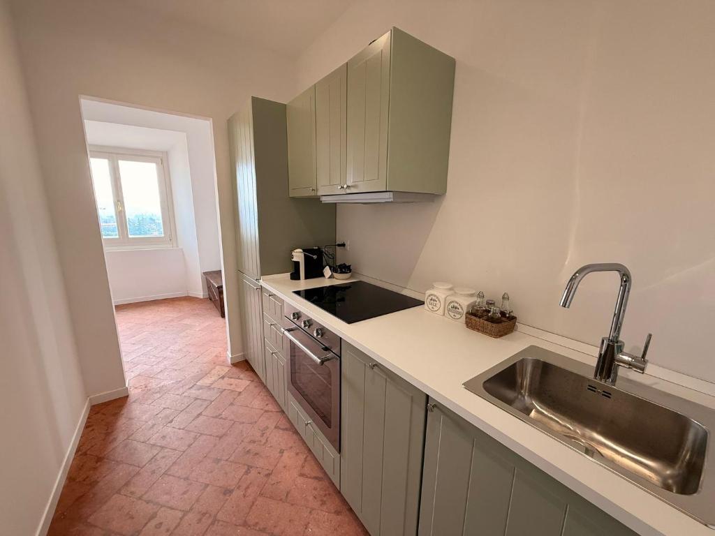 a kitchen with a sink and a counter top at Suite Agli Spaldi in Iesi