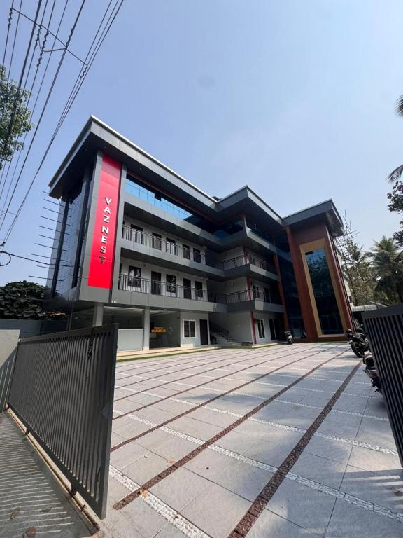 a building with a red sign in front of it at vaznest in Nilambūr