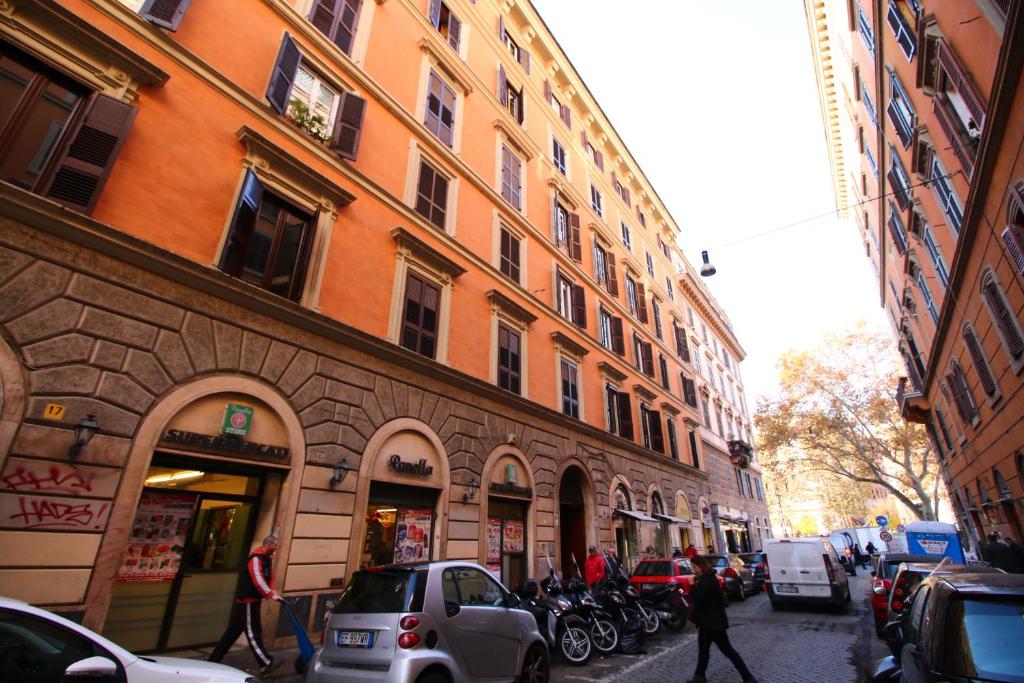 a street with cars parked on the side of a building at Magenta Collection Del Grande in Rome