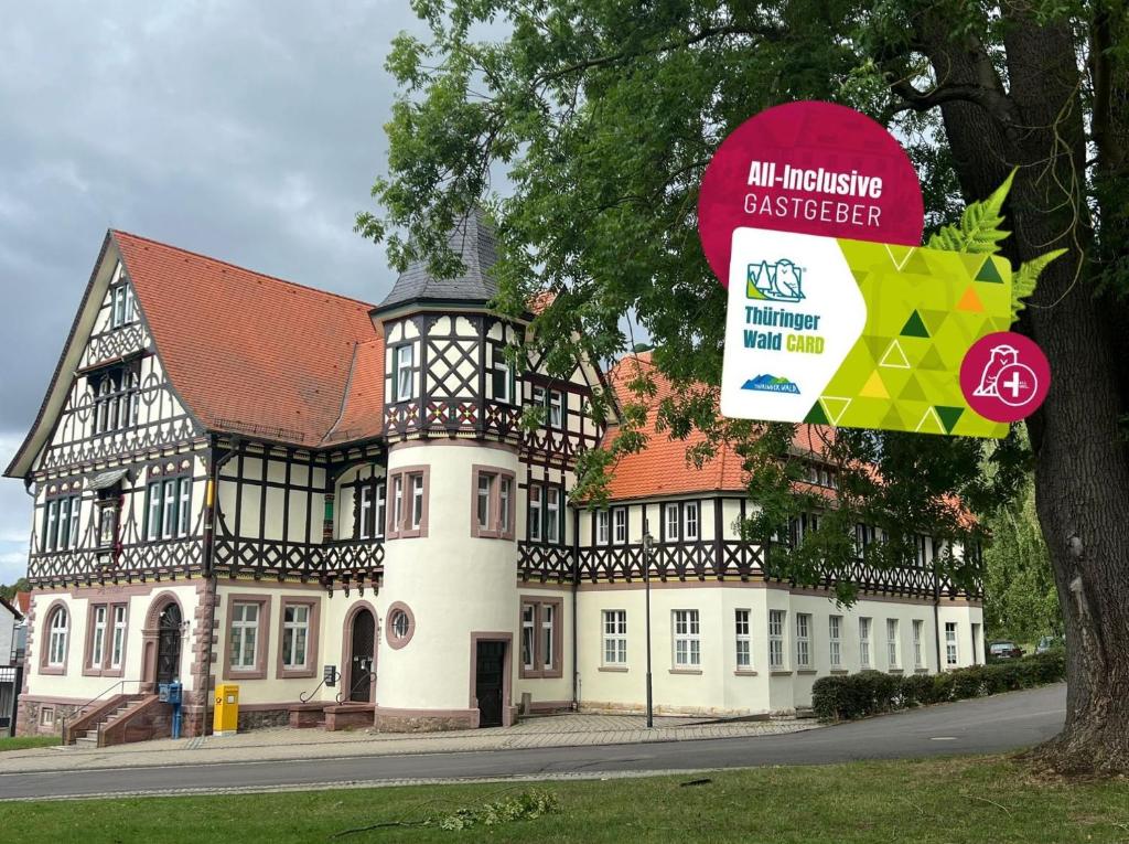a building with a sign in front of it at Ferienwohnungen Historische Post in Bad Liebenstein