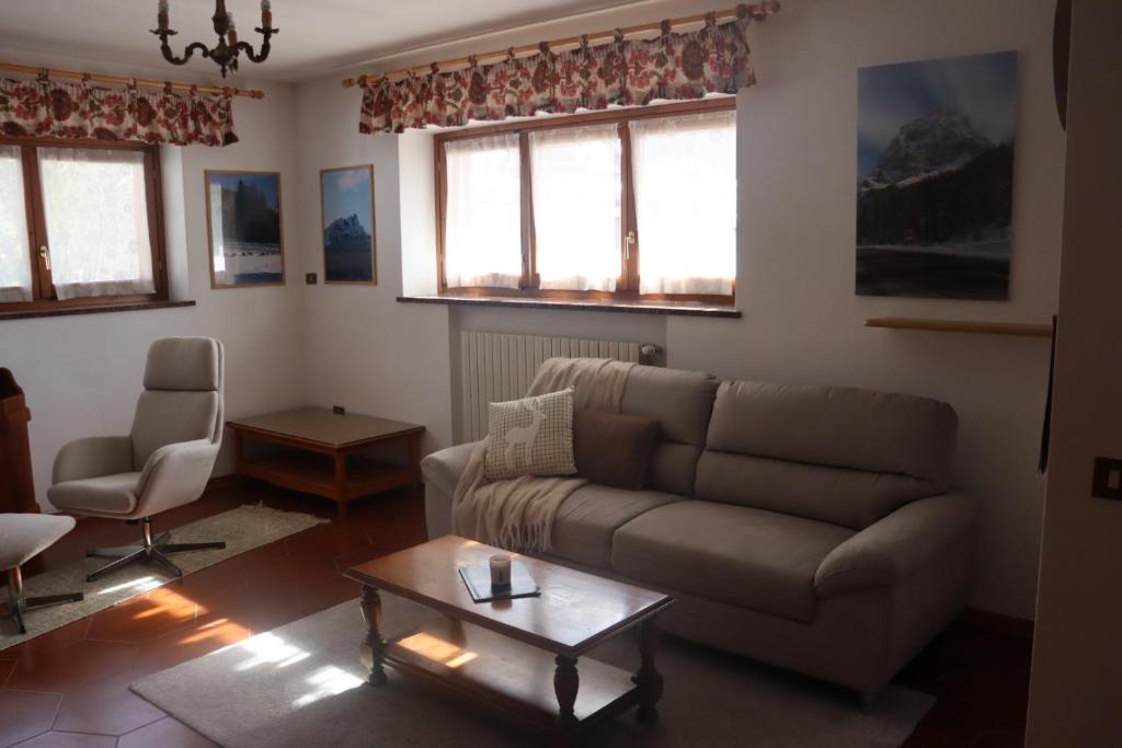 a living room with a couch and a table at Al Roser in Forno di Zoldo