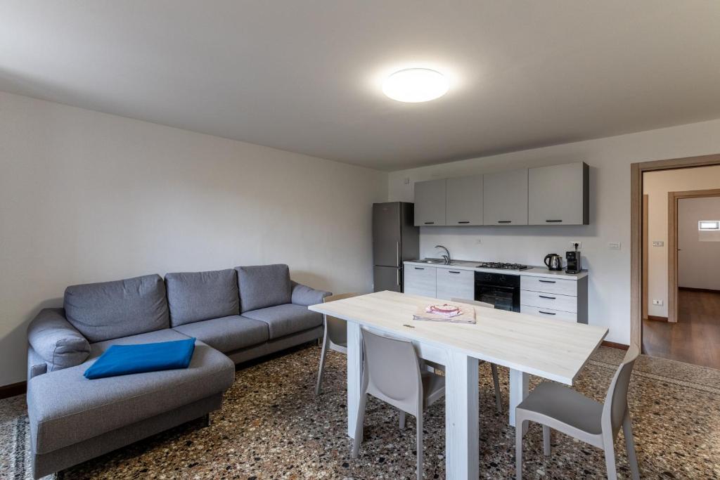 a living room with a couch and a table at La Cort di Vigje 2 in Ovaro