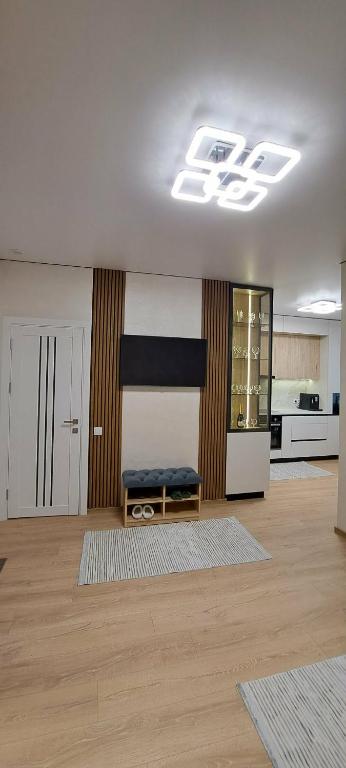 a living room with a bench in the middle at SkyHouse&PrivateGarage in Chişinău