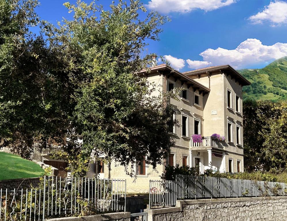 a large house with a fence in front of it at Villa della Comare in Osigo