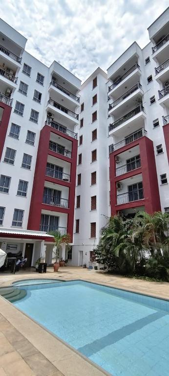 a pool in front of two large apartment buildings at Shanzu Beach Homes 105 in Mombasa