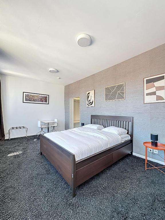 a bedroom with a large bed in a room at Keyless Hotel - Van Gaver in Brussels