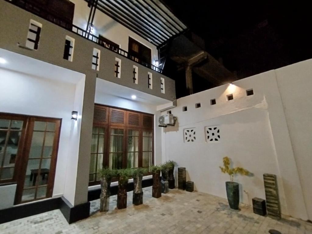 a large building with potted plants in a courtyard at Villa Mango in Negombo