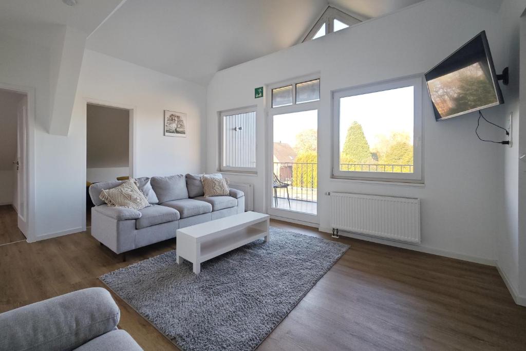 a living room with a couch and a table at Pelster´s Apartments in Diepholz