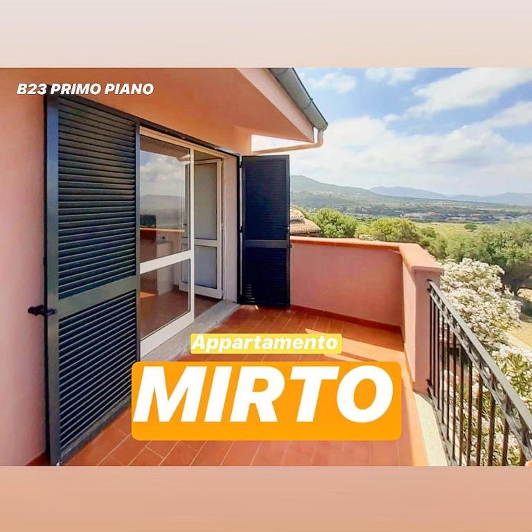 a balcony of a house with a mirino sign on it at Badesi Apartment - Mirto in Badesi