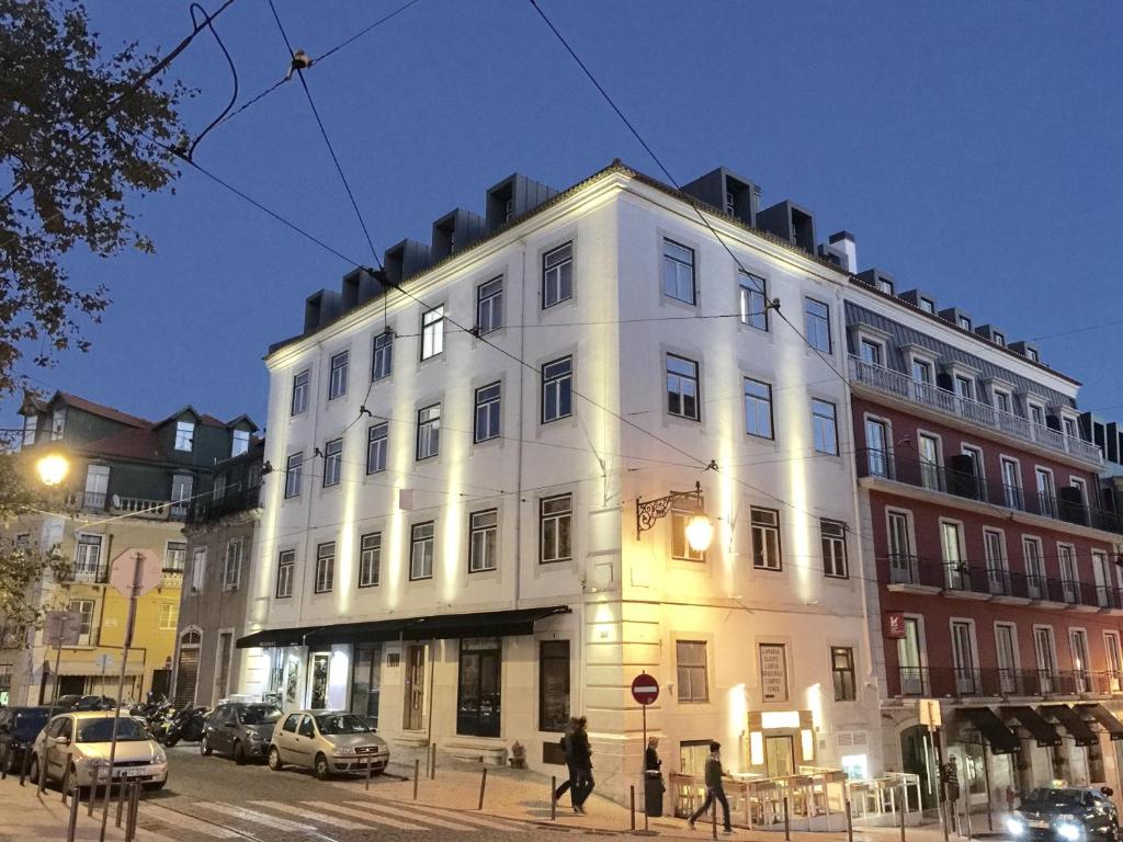 a large white building on a city street at night at Chiado Arty Flats in Lisbon