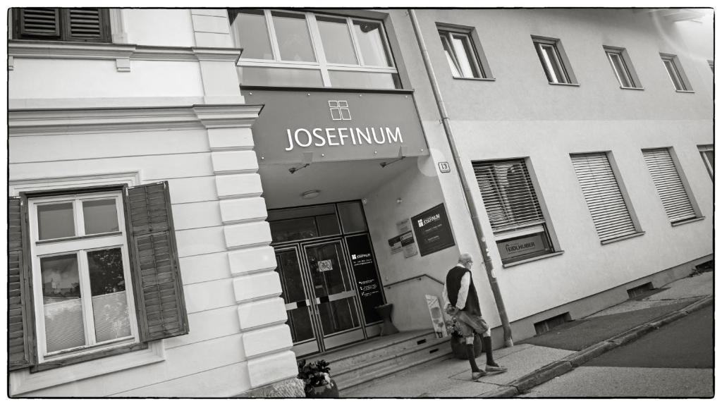 a man standing in front of a building at Frühstückspension Josefinum in Bad Aussee