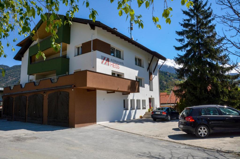 a building with a car parked in front of it at Austrian Motel Heiss in Prutz