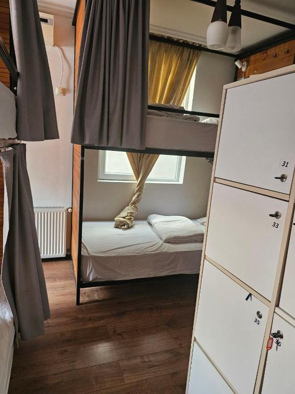 a small room with a bunk bed and a bunk bed at Hostel Hostel in Batumi