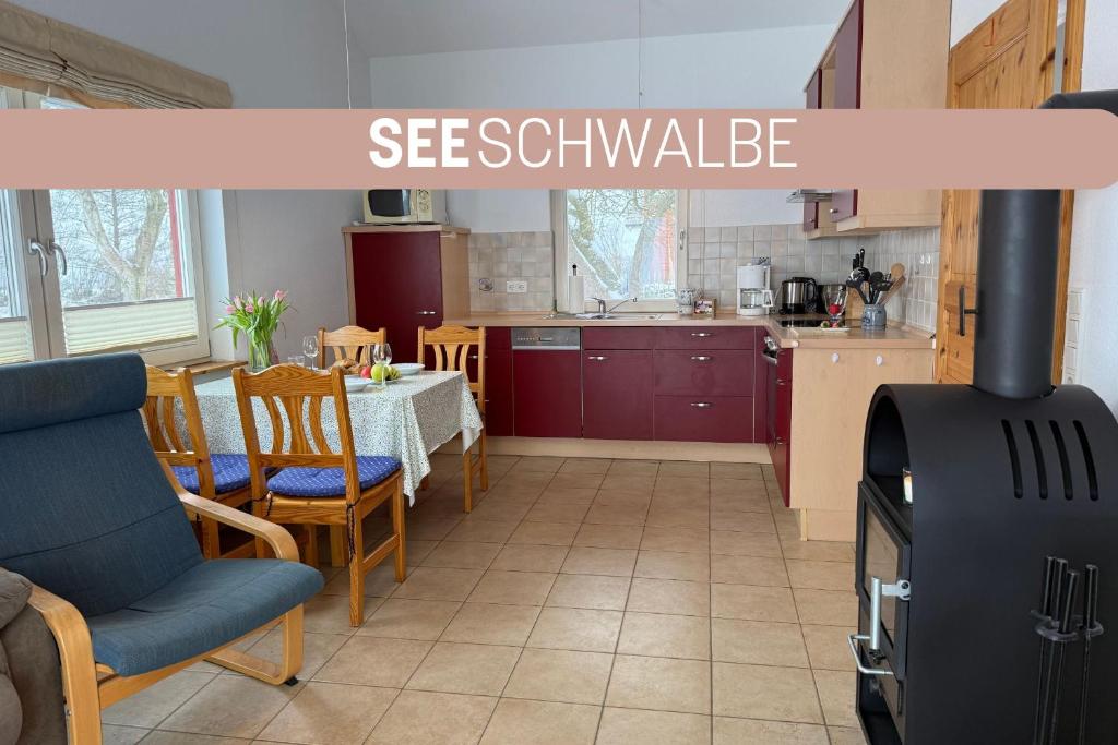 a kitchen with a table and a stove in a room at Seeschwalbe in Munkbrarup