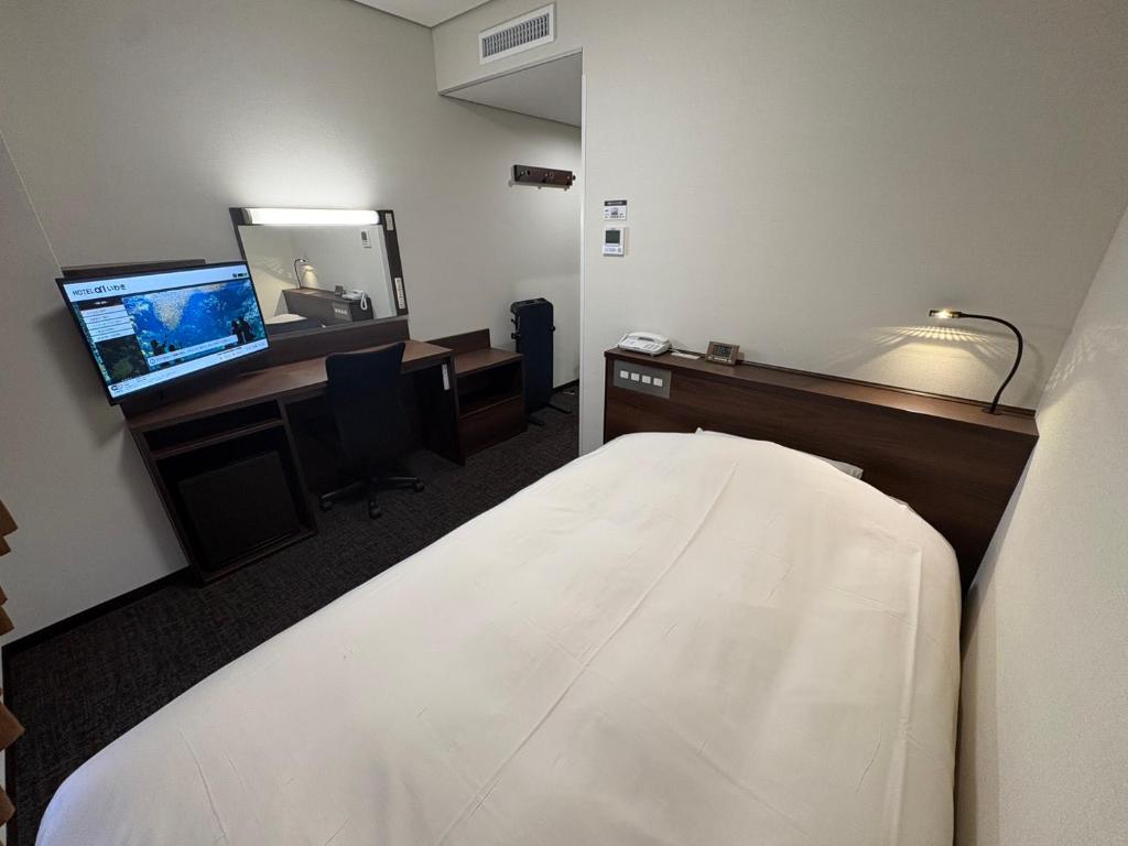 Кровать или кровати в номере Hotel Alpha-One Iwaki