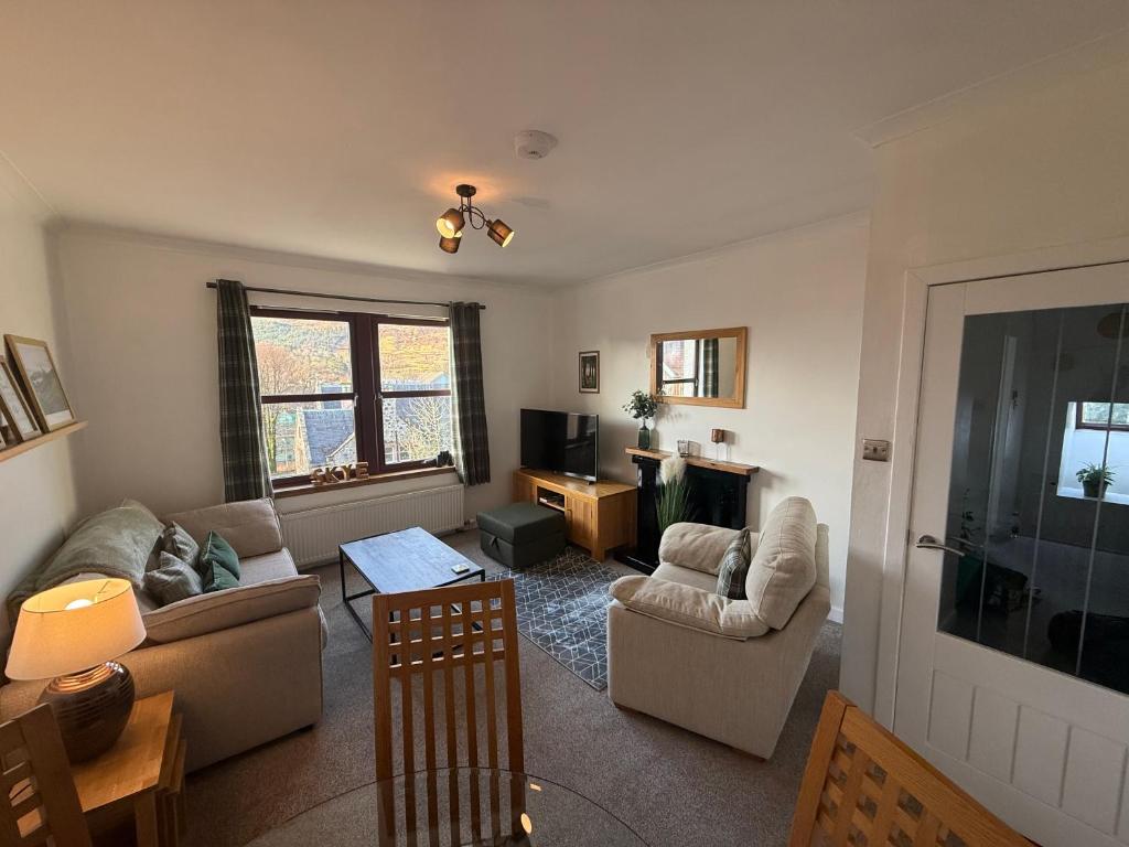a living room with two couches and a television at Misty Isles View in Portree
