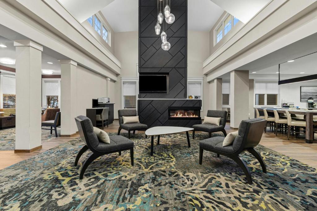 a living room with chairs and a fireplace at Residence Inn Paducah in Paducah
