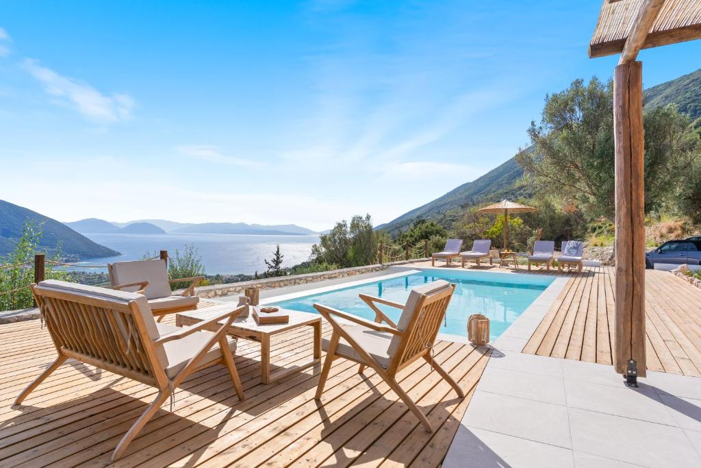 a villa with a pool and a deck with chairs at ELGIAN Luxury Villa -Private Pool & Sea View in Póndi