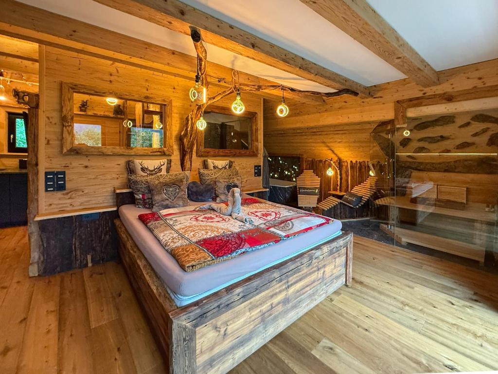a bedroom with a bed in a log cabin at Bergromantik Ferienwohnung Charisma mit eigener Sauna, Whirlpool und Bergblick in Marktschellenberg
