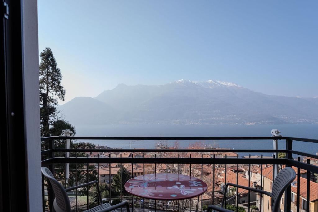 a balcony with a table and a view of the beach at House Carla in Bellano
