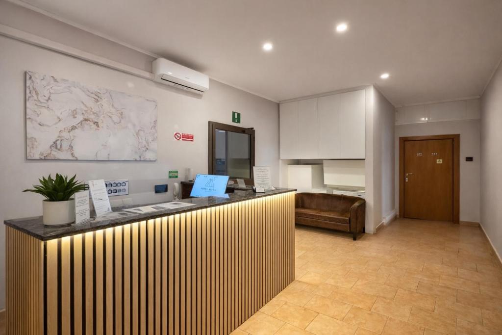 a lobby with a counter in a room with a kitchen at Hotel Atena in Milan