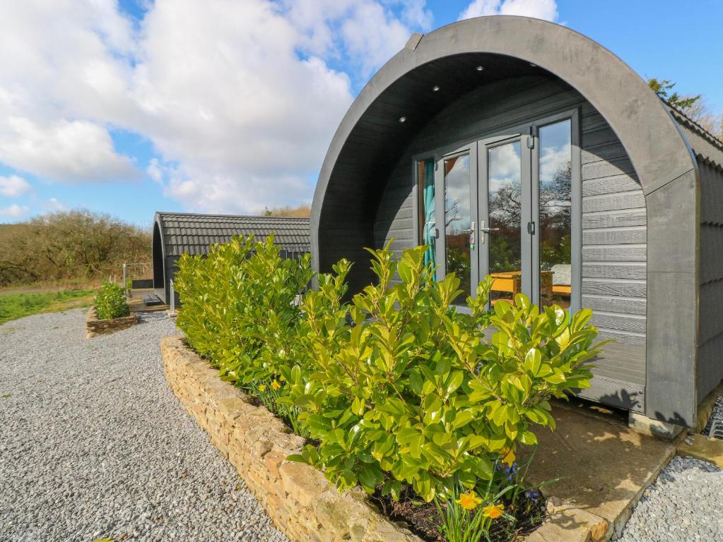 a small gray house with a circular roof at Lodge 3 in Llanelli