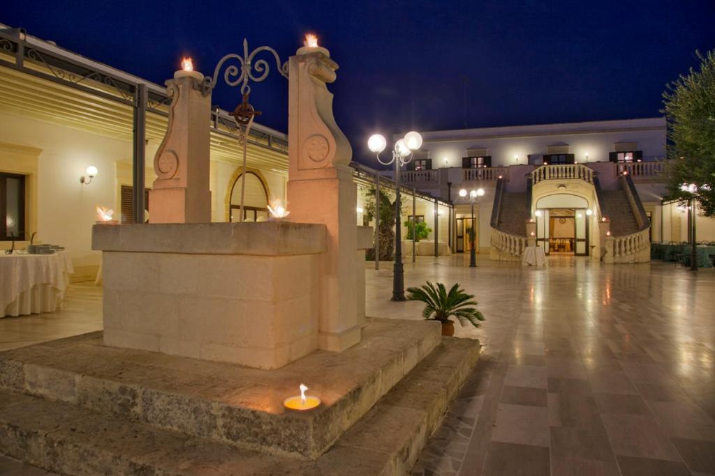 a candle in the middle of a courtyard at night at Tenuta Caradonna in Lequile