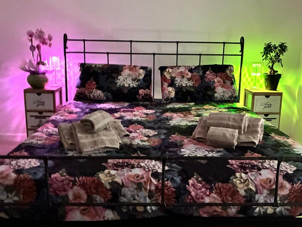a bedroom with a bed with a floral quilt at 33 Joy Dreams in Sandra