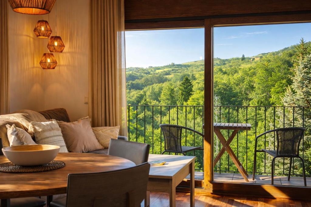 a living room with a table and a large window at Allotjaments Vall de Muntanyes in Molló