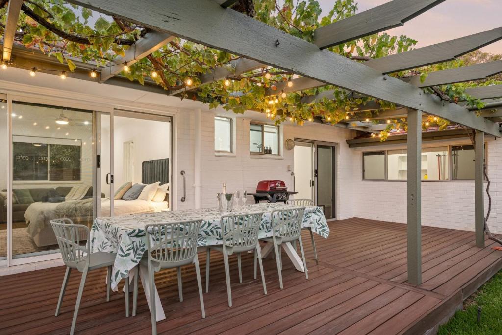a dining room with a table and chairs on a deck at Beach House Family Friendly Enclosed Yard in Rockingham