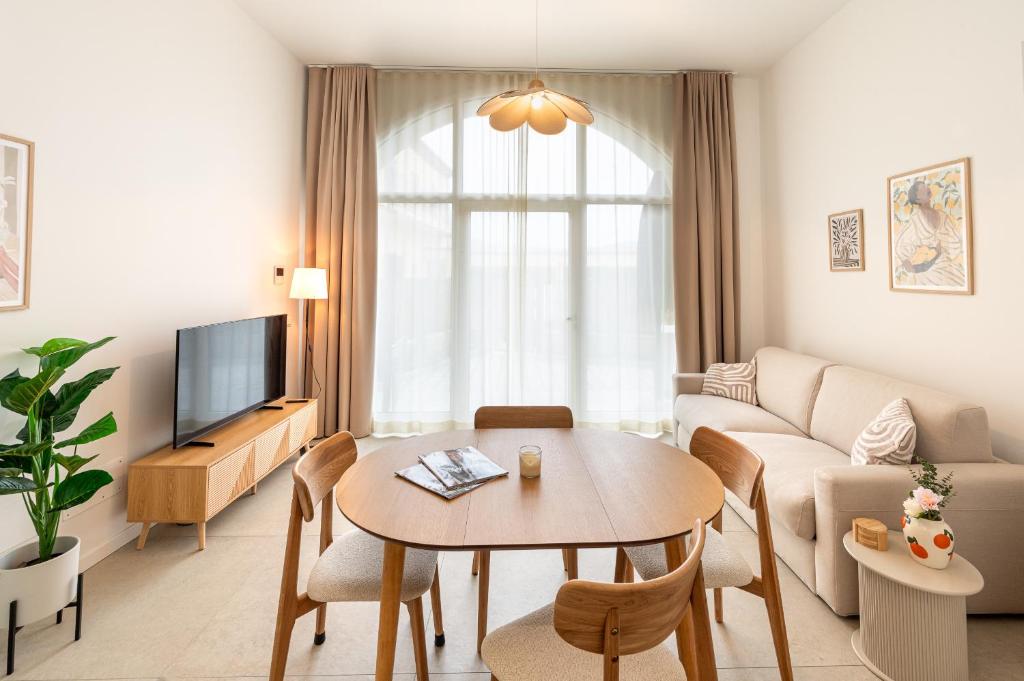 a living room with a table and a couch at Erbusco Charme Apartment in Erbusco