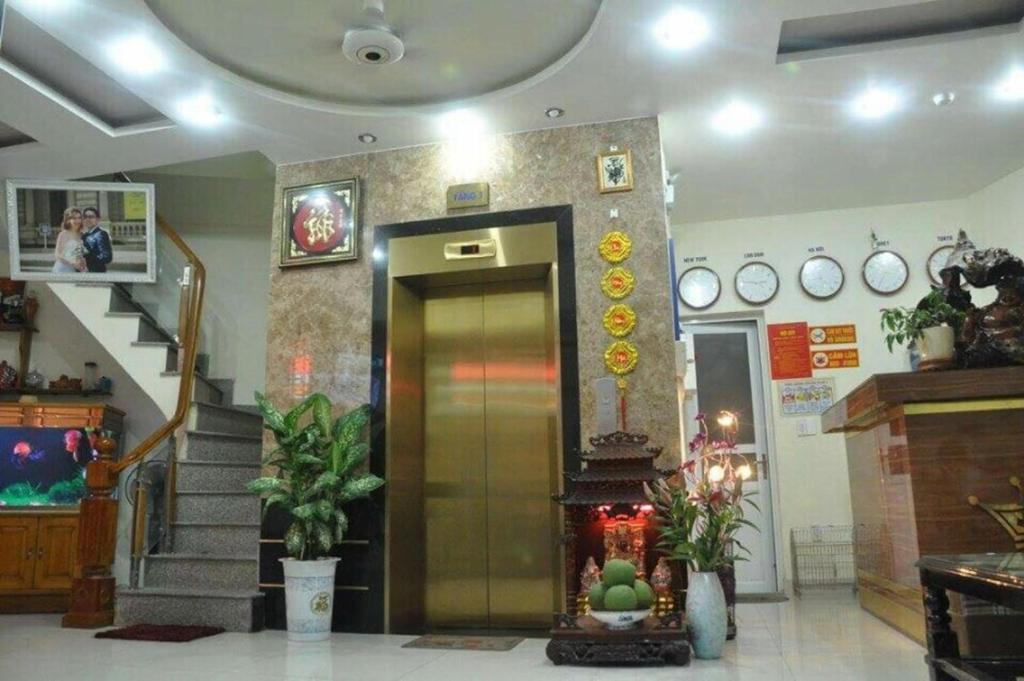 a lobby with a staircase and a elevator with a door at Tay Dai Duong Guesthouse in Hai Phong