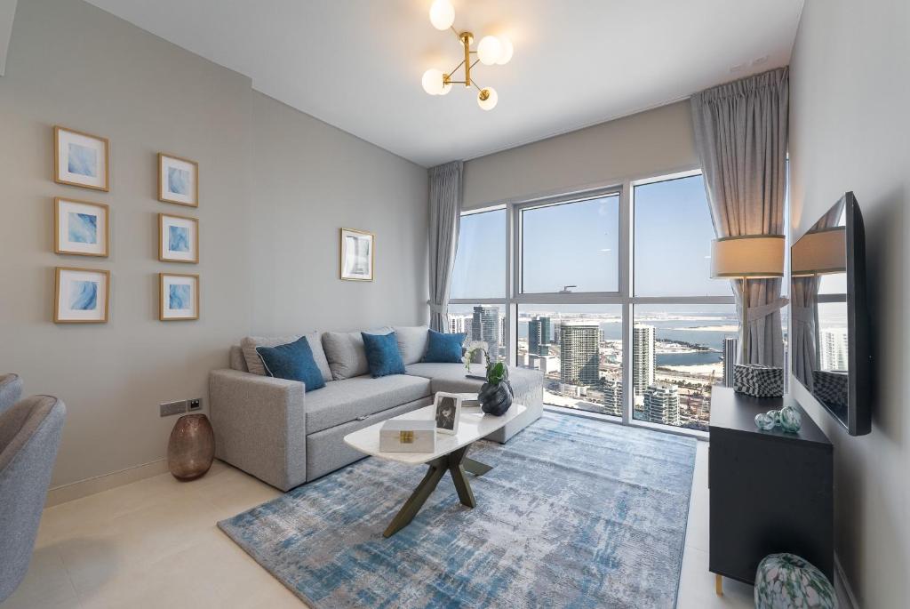 a living room with a couch and a table at Urban Chic - Radiant in Abu Dhabi