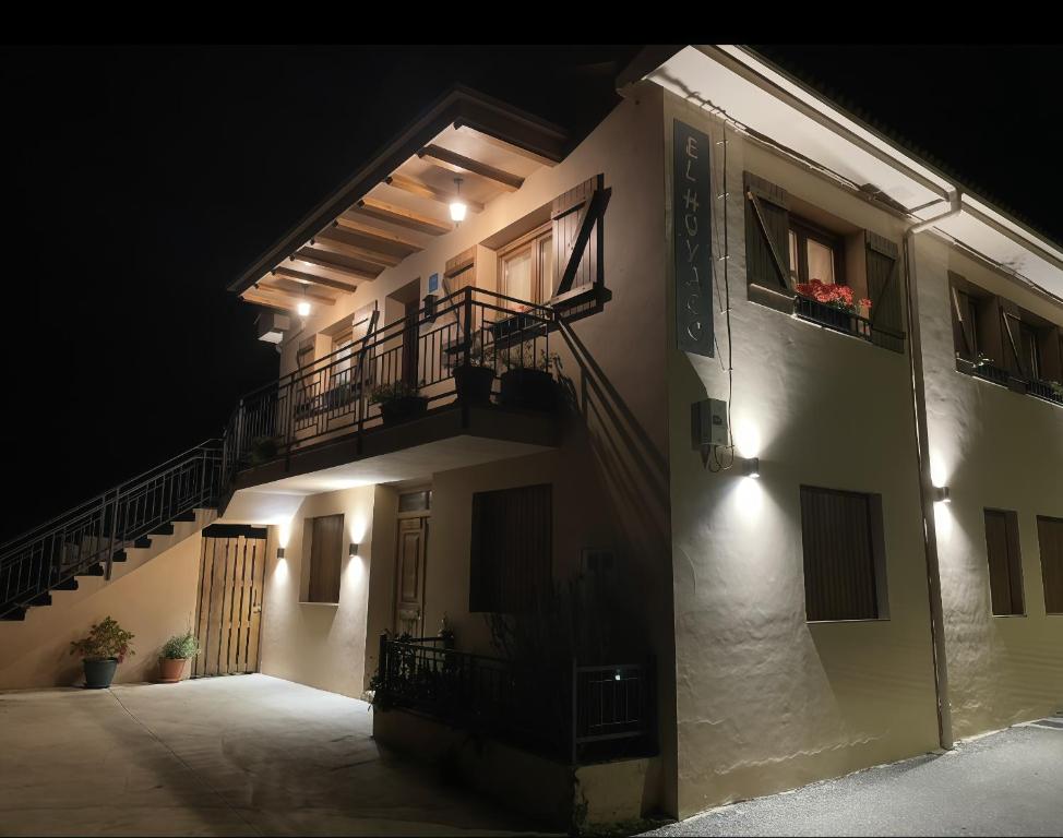 a building with a balcony and stairs at night at El Hoyaco in Los Espejos de la Reina