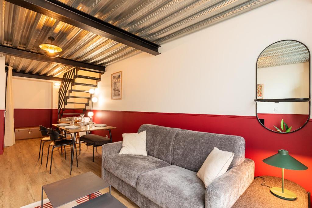 a living room with a couch and a table at Zest Vendome - Saxe Gambetta in Lyon