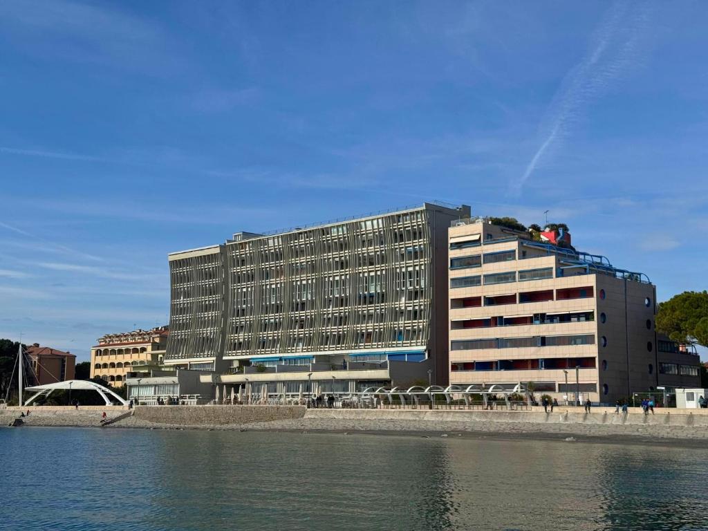 a large building next to a body of water at Appartamento Zipser II in Grado