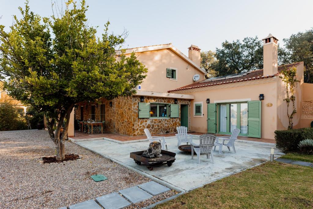 a patio with a table and chairs in front of a house at Vale De Ferreiros in Abrantes
