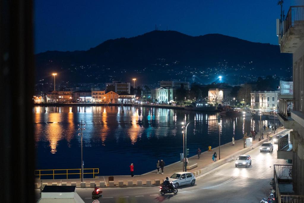 a city at night with a body of water at Gaia Apartments in Mytilene